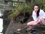 Raven Haired Girl Pees Near The River