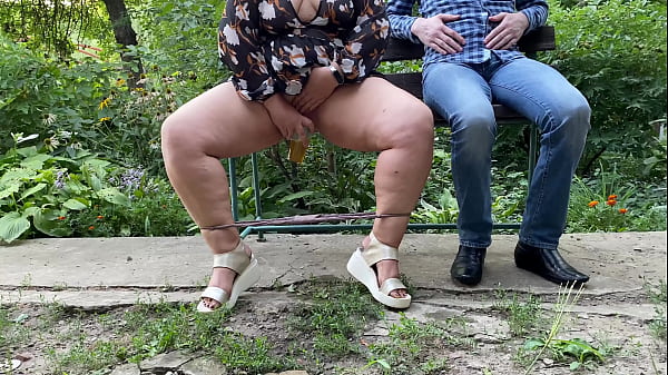 Sexy MILF with gorgeous legs pisses into a glass and gives it to a stranger